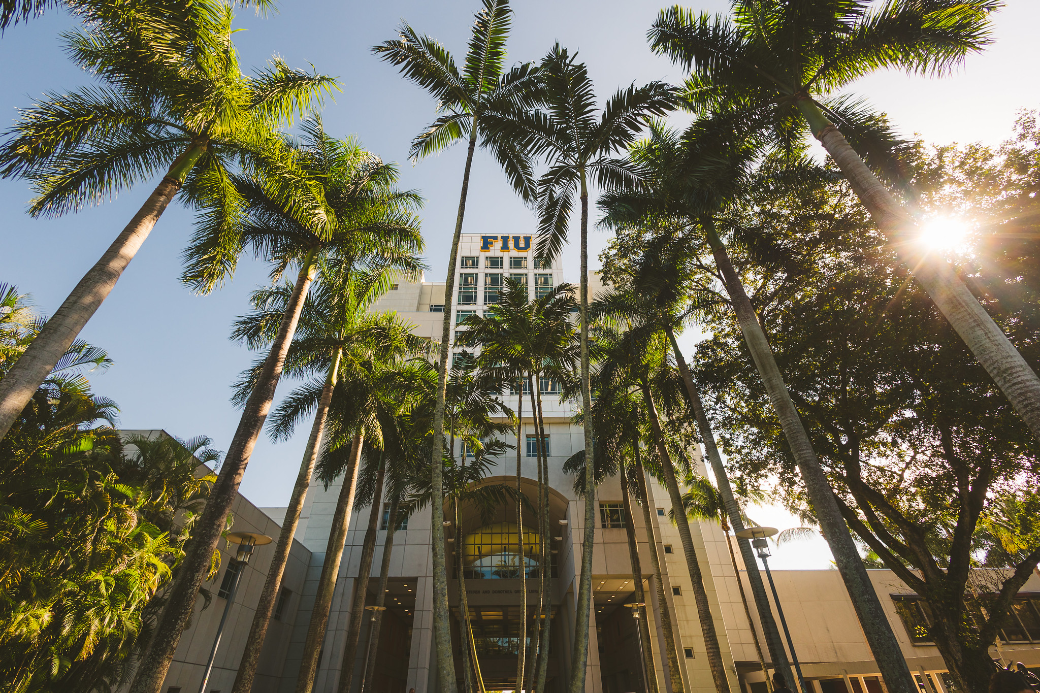 Landscape shot of FIU library with sign that says "Welcome"
